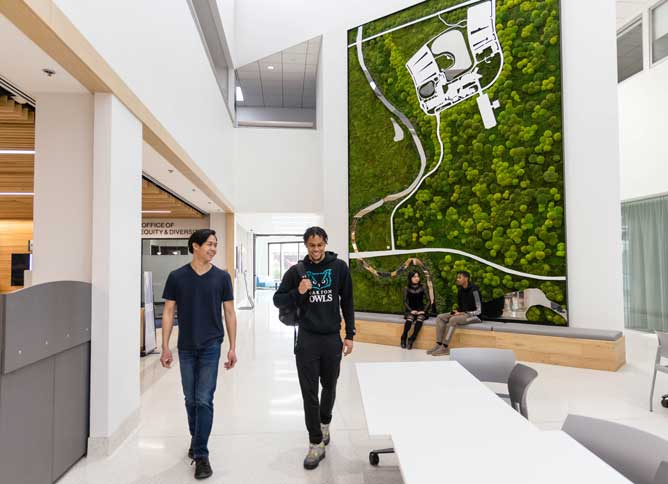 Students walking down the hallway on Student Street at Oakton College's Des Plaines campus.