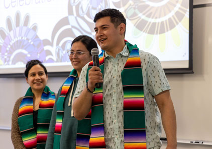 Group of students from Latine club celebrating graduation with special stole.