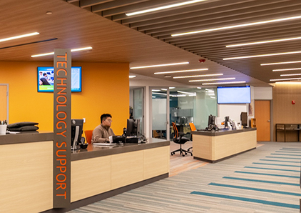 IT tech support working inside the Learning Commons.